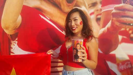 A girl holding personalized plastic Coca-Cola cup at AFC Asian Cup 2019